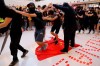 Protesters walk on a Chinese national flag during a protest at a mall in Hong Kong on Sunday, Sept. 22, 2019. Hong Kong's pro-democracy protests, now in their fourth month, have often descended into violence late in the day and at night. A hardcore group of protesters says the extreme actions are needed to get the government's attention. (AP Photo/Kin Cheung)
