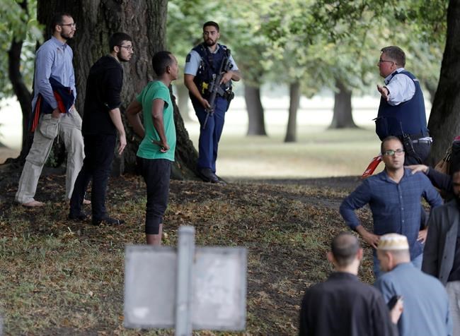Police attempt to move people away from outside a mosque in central Christchurch, New Zealand, Friday, March 15, 2019. Many people were killed in a mass shooting at a mosque in the New Zealand city of Christchurch on Friday, a witness said. Police have not yet described the scale of the shooting but urged people in central Christchurch to stay indoors. (AP Photo/Mark Baker)