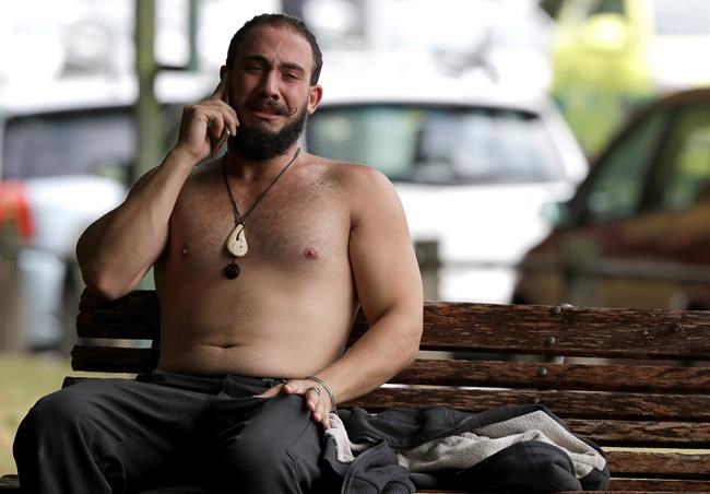A man reacts as he speaks on a mobile phone near a mosque in central Christchurch, New Zealand, Friday, March 15, 2019. Multiple people were killed in mass shootings at two mosques full of people attending Friday prayers, as New Zealand police warned people to stay indoors as they tried to determine if more than one gunman was involved.(AP Photo/Mark Baker)