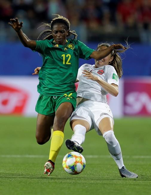 Cameroon's Claudine Meffometou, left, and Canada's Janine Beckie battle for the ball during the Women's World Cup Group E soccer match between Canada and Cameroon in Montpellier, France, Monday, June 10, 2019. (AP Photo/Claude Paris)