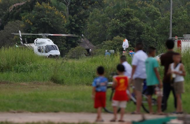 A helicopter believed to be carrying one of the boys rescued from the flooded cave land in Chiang Rai as divers continue to extract the remaining boys and their coach trapped at Tham Luang cave in the Mae Sai district in Chiang Rai province, northern Thailand, Tuesday, July 10, 2018. Thai Navy SEALs say all 12 boys and their coach were rescued from the cave, ending an ordeal that lasted more than 2 weeks. (AP Photo/Vincent Thian)