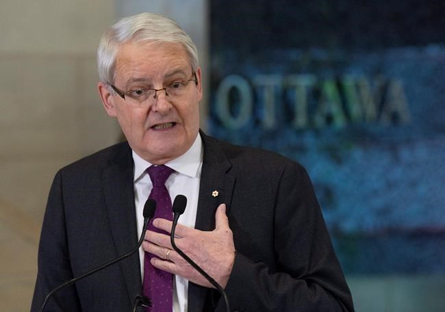 Transport Minister Marc Garneau speaks about passenger rights during a news conference at the airport in Ottawa, Monday December 17, 2018. THE CANADIAN PRESS/Adrian Wyld