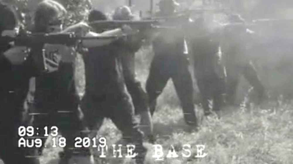 Seven masked members of The Base shoot shotguns and semi-automatic rifles during a recent paramilitary