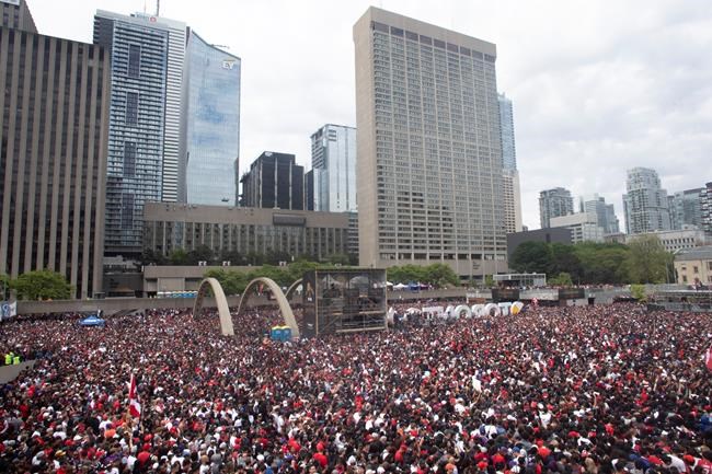 Crowds gather in Nathan Phillips Square as they prepare to celebrate the Toronto Raptors winning the NBA Championship in Toronto on Monday, June 17, 2019. THE CANADIAN PRESS/Chris Young