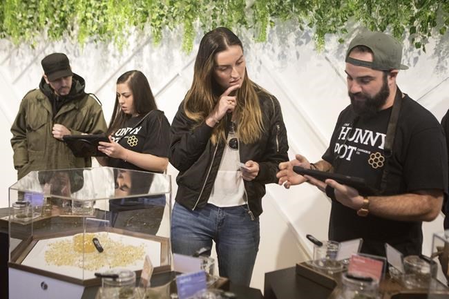 Customers shop for cannabis on the first morning of opening at Toronto's