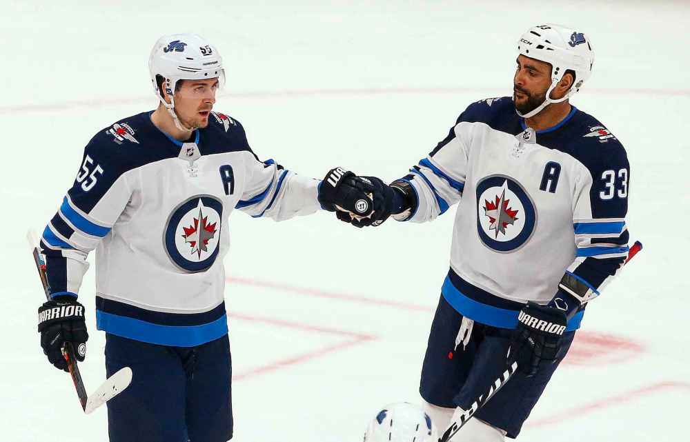 Winnipeg Jets center Mark Scheifele (55) celebrates his goal against the Arizona Coyotes with defenseman Dustin Byfuglien (33) during the first period of an NHL hockey game Saturday, April 6, 2019, in Glendale, Ariz. (AP Photo/Ross D. Franklin)