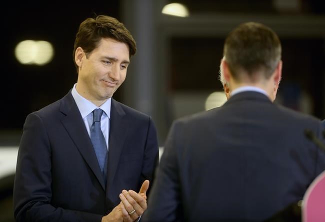 Winnipeg mayor Brian Bowman finishes speaking as Prime Minister Justin Trudeau looks on at a transit funding announcement at the Winnipeg Transit bus barn, Tuesday, February 12, 2019. THE CANADIAN PRESS/Trevor Hagan