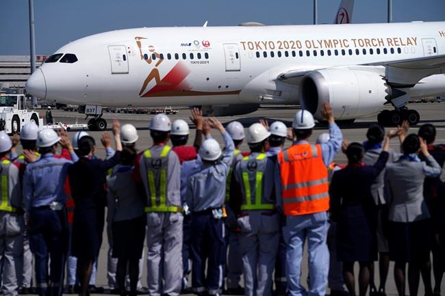 Ground crews of Japanese airlines wave to the special