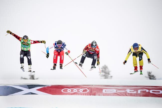 Daniel Bohnacker, wearing yellow top, of Germany crosses the finish line to win followed by Kevin Drury, red, second from right, of Canada, Ryan Regez, blue, of Switzerland and Brady Leman, green, of Canada in action during the FIS World Cup Men's Freestyle Skicross final in Idre, Sweden, on Sunday Jan. 26, 2020. (Pontus Lundahl / TT via AP)