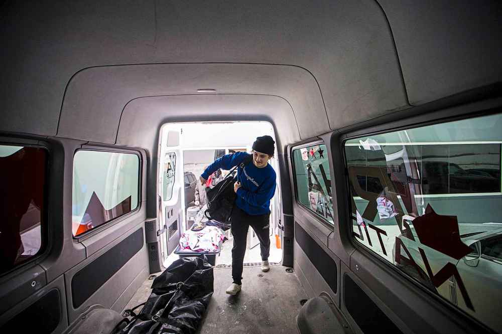 Karter Prosofsky loads his hockey bag into the van to be transported to the arena for the game.