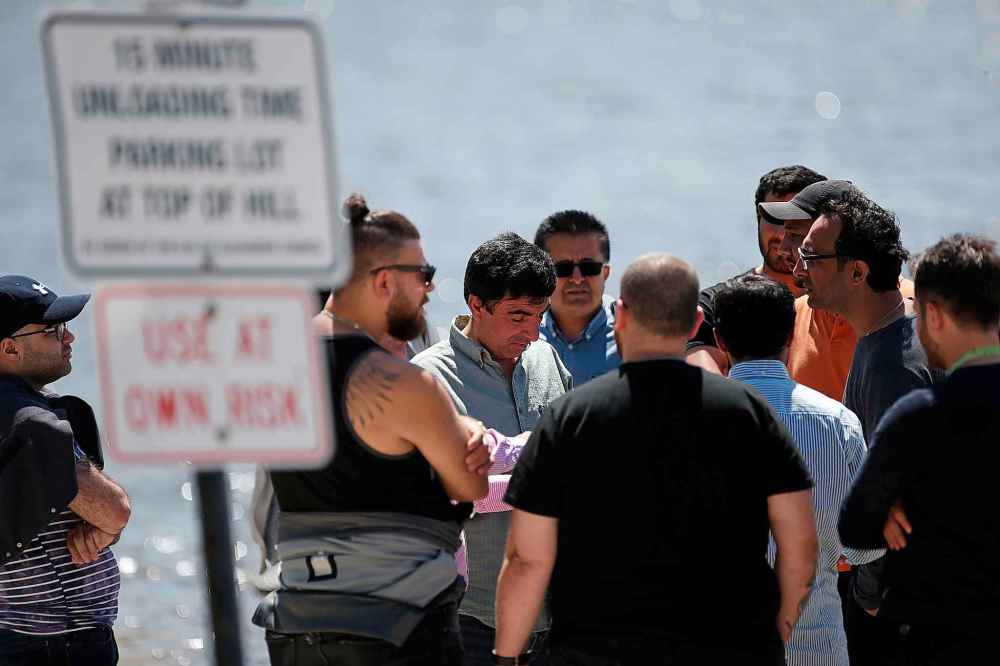 Members of the Kurdish community talk and wait for answers from the RCMP's search for Ali. (John Woods / Winnipeg Free Press)