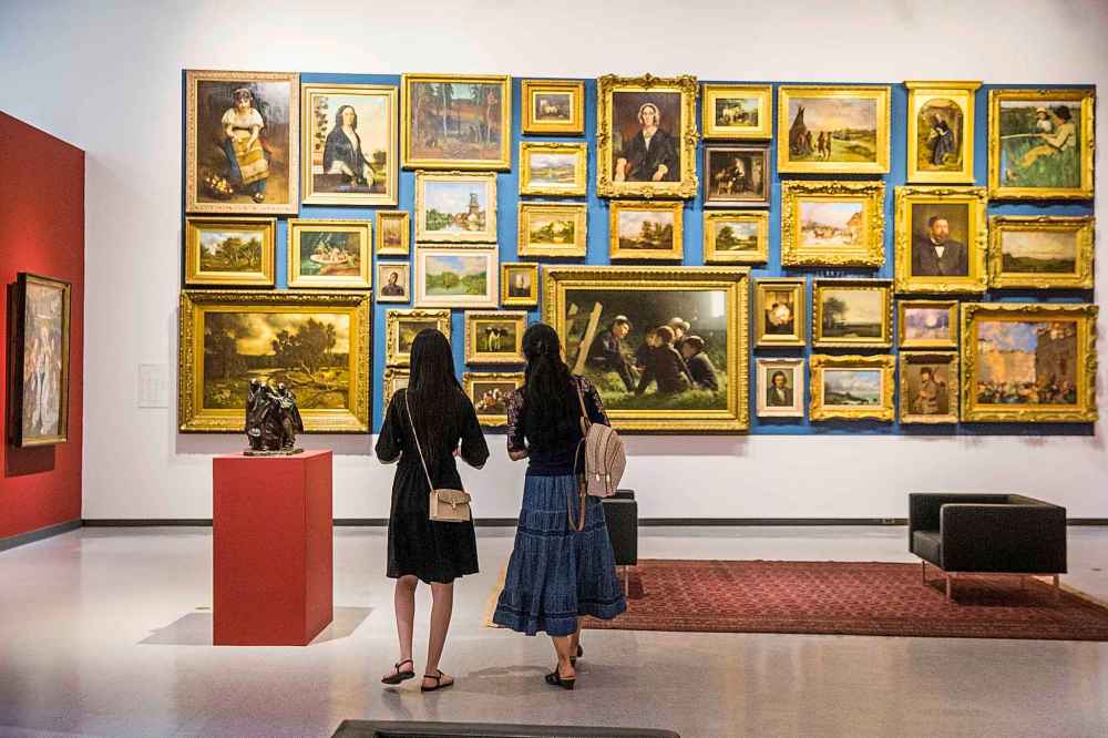 Linjie Huang (left) and her mom, Xuelian Zhang, look at art at the WAG. Even though they've lived in Winnipeg for two years, this was their first visit to the gallery. (Mikaela MacKenzie / Winnipeg Free Press)