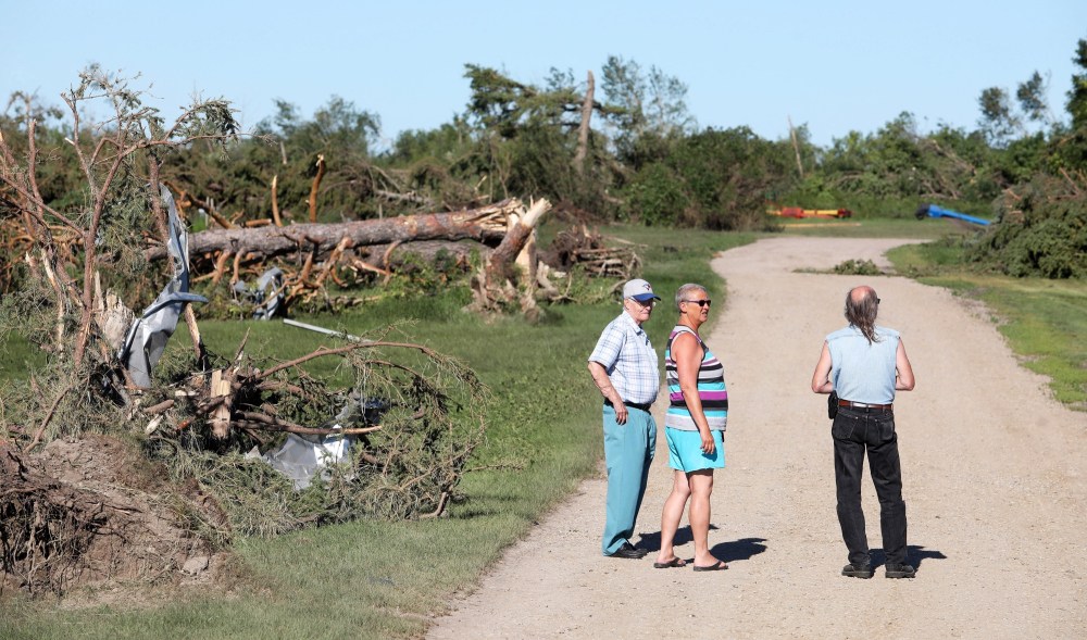 Tim Smith/The Brandon Sun
Locals survey the damage at Giovanni Colangelo's farm south of Virden on Saturday morning after a powerful tornado tore through the farm Friday evening.