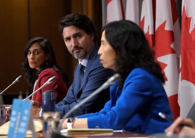 Prime Minister Justin Trudeau and Minister of Public Services and Procurement Anita Anand listen to Chief Public Health Officer of Canada Dr. Theresa Tam during a news conference on the COVID-19 pandemic on Parliament Hill in Ottawa, on Friday, Sept. 25, 2020. THE CANADIAN PRESS/Justin Tang