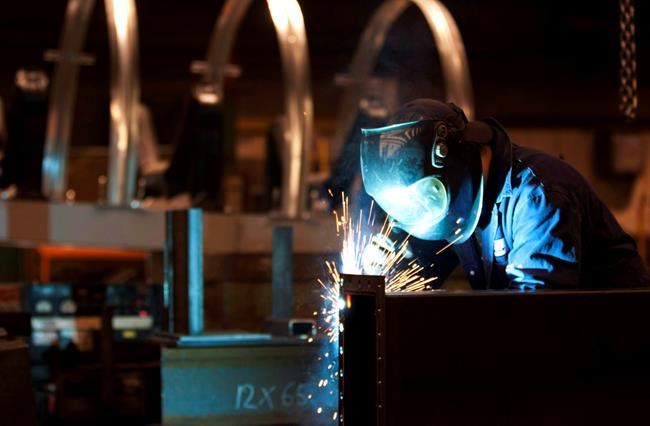 A welder works in a factory in Quebec City, Tuesday, Feb. 28, 2012. THE CANADIAN PRESS/Jacques Boissinot