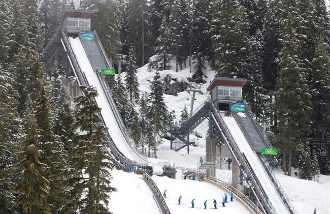 Course workers prepare the landing area at the ski jump venue in Whistler Olympic Park in Whistler, B.C. Friday, Feb. 5, 2010. THE CANADIAN PRESS/Jonathan Hayward