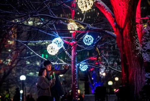 People take a photo together during the opening night of Christmas Lights Across Canada, in Ottawa, on Wednesday, Dec. 4, 2019. The likelihood that most Canadians will enjoy a holly jolly Christmas season of gatherings, caroling and travel is unlikely, say public health experts who encourage those who revel in holiday traditions to accept more sacrifices ahead. THE CANADIAN PRESS/Justin Tang