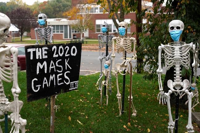 Coronavirus-themed Halloween decorations are displayed on a lawn in Tenafly, N.J., Thursday, Oct. 22, 2020. As spooky season reaches its climax in a particularly frightening year, some historians argue the COVID-19 pandemic offers an opportunity to explore a more cerebral side of Halloween. THE CANADIAN PRESS/AP Photo/Seth Wenig