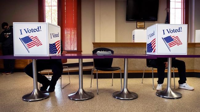 Cowlitz County voters fill our their ballots while following social distancing protocols, at the Cowlitz County Administration Building in Kelso, Wash., Tuesday, Nov. 3, 2020 THE CANADIAN PRESS/AP, Courtney Talak/The Daily News