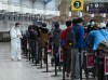 People line up and check in for an international flight at Pearson International Airport during the COVID-19 pandemic in Toronto on Wednesday, Oct. 14, 2020. A report from Canada's transportation regulator says poor preparation by airlines for the country's passenger rights charter resulted in communication problems that frustrated travellers and denied some their proper compensation following flight delays or cancellations. THE CANADIAN PRESS/Nathan Denette