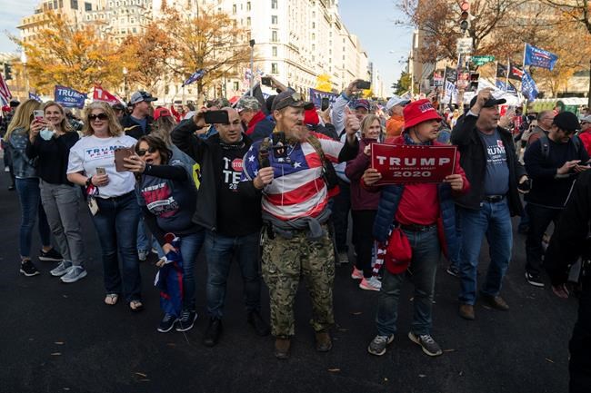 Supporters of President Donald Trump cheer as his motorcade drives past a rally of supporters near the White House, in Washington, Saturday, Nov. 14, 2020. Diehard Donald Trump supporters are gathering in the national capital in solidarity with the president's efforts to defy last week's election results. THE CANADIAN PRESS/AP-Evan Vucci