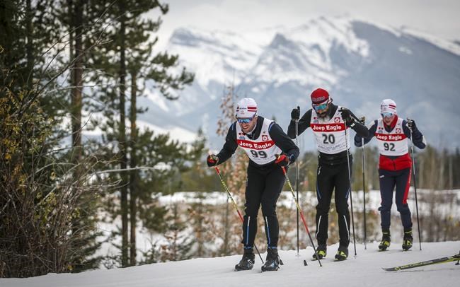 Canadian Cross-Country Ski Team members, left to right, Russell Kennedy, Brian McKeever, and Xavier McKeever, ski up a hill during early season training in Canmore, Alta., Monday, Oct. 19, 2020. THE CANADIAN PRESS/Jeff McIntosh