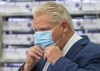 Ontario Premier Doug Ford puts his mask back on during the daily briefing at Humber River Hospital in Toronto on Tuesday November 24, 2020. Ford says he wants a clear delivery date for the province's share of COVID-19 vaccines, stressing that