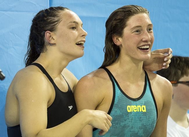 Penny Oleksiak (left) hugs Taylor Ruck after winning the Women's 200 Free at the 2019 Canadian Swimming Trials in Toronto on April 6, 2019. Canada's Olympic and Paralympic swim trials will be contracted to reduce the risk of exposure to the COVID-19 virus. Canada's Olympic and Paralympic swim teams for this summer's Tokyo Games will be named following the April 7-11 trials at the Toronto Pan Am Sports Centre. THE CANADIAN PRESS/Frank Gunn