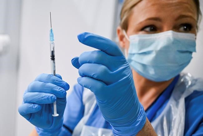 Paula McMahon prepares a shot of the Pfizer-BioNTech COVID-19 vaccine, as the mass public vaccination program gets underway, at the NHS Louisa Jordan Hospital in Glasgow, Scotland, Tuesday Dec. 8, 2020. Nova Scotia will receive 1,950 doses of Pfizer's COVID-19 vaccine for an initial test run next week. THE CANADIAN PRESS/AP-POOL, Jeff J Mitchell