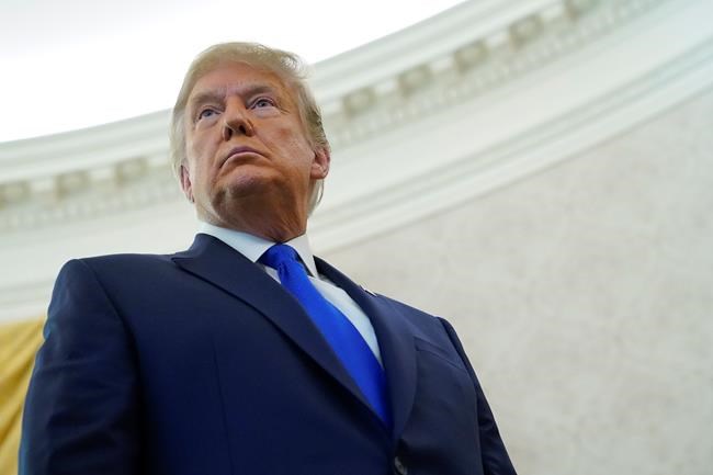 President Donald Trump listens to a reporter's question in the Oval Office of the White House on Dec. 7, 2020, in Washington. THE CANADIAN PRESS/AP, Patrick Semansky