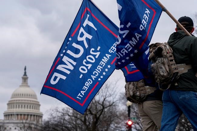Trump supporters walk past the dome of the Capitol Building in Washington, Wednesday, Jan. 6, 2021. THE CANADIAN PRESS/AP/Andrew Harnik