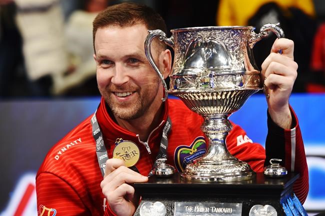 Team Newfoundland and Labrador skip Brad Gushue poses with the Brier Tankard trophy after defeating Team Alberta in the Brier curling final in Kingston, Ont., on Sunday, March 8, 2020. Curling Canada is expanding the field for the Scotties Tournament of Hearts and Tim Hortons Brier.THE CANADIAN PRESS/Sean Kilpatrick