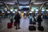 A WestJet employee assists a person checking in for a domestic flight at Vancouver International Airport, in Richmond, B.C., on January 21, 2021. THE CANADIAN PRESS/Darryl Dyck