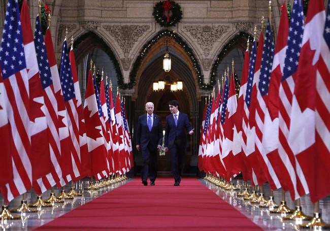 Prime Minister Justin Trudeau and US vice-president Joe Biden walk down the Hall of Honour on Parliament Hill in Ottawa on Friday, December 9, 2016. THE CANADIAN PRESS/Patrick Doyle