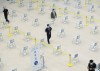Health-care workers walk through the post vaccine waiting area at a mass COVID-19 vaccination clinic for Peel Region during the COVID-19 pandemic in Mississauga, Ont., Monday, March 1, 2021. THE CANADIAN PRESS/Nathan Denette