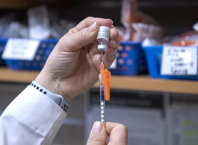 A pharmacist prepares the Pfizer-BioNTech COVID-19 mRNA vaccine at a pharmacy prototype clinic in Halifax on March 9, 2021. The CANADIAN PRESS/Andrew Vaughan