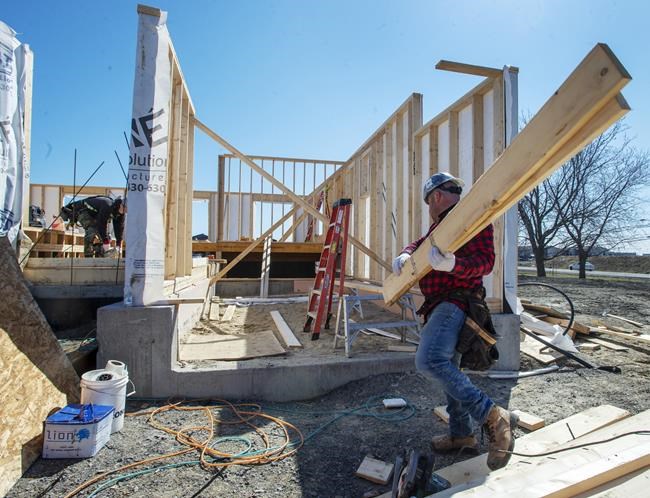 The federal government has tweaked its housing and infrastructure plans in the budget, but held back on an overhaul. Charles Rochfort, left, and Jonathan Grenier work on a home as Quebec lifts the ban on residential construction due to the COVID-19 pandemic Monday April 20, 2020 in Deux-Montagnes, Que. THE CANADIAN PRESS/Ryan Remiorz
