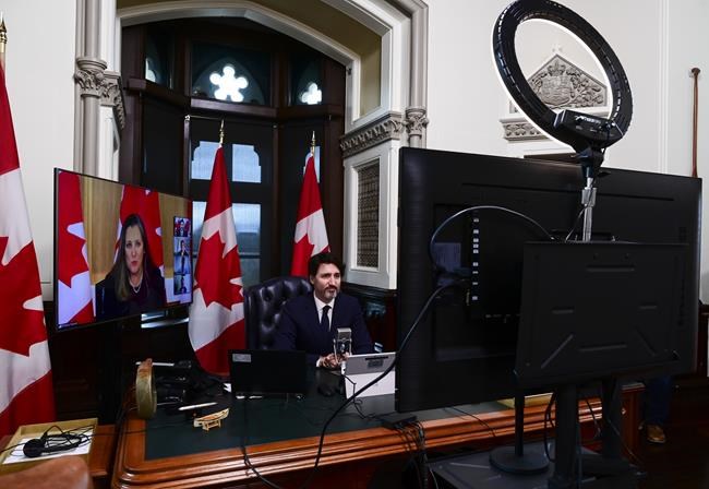 Prime Minister Justin Trudeau is joined virtually by Minister of Finance Chrystia Freeland as they talk online to a group of front-line pharmacists from across the country to discuss the ongoing vaccination efforts in the fight against COVID‑19, from the Prime Ministers office on Parliament Hill in Ottawa on Tuesday, April 20, 2021. THE CANADIAN PRESS/Sean Kilpatrick