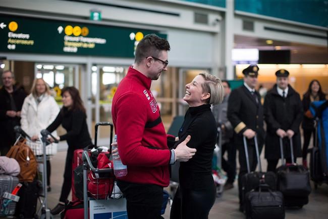 Olympic gold medallist in two-man bobsleigh, Alexander Kopacz, left, of London, Ont., shares a moment with his girlfriend Cassie Hawrysh after arriving from South Korea at Vancouver International Airport in Richmond, B.C., Monday, Feb. 26, 2018. THE CANADIAN PRESS/Darryl Dyck