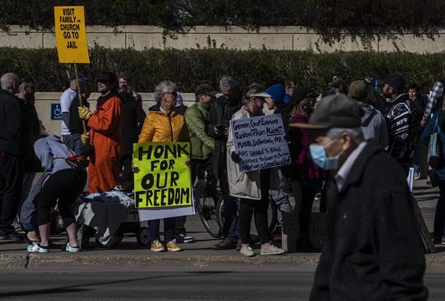 Supporters of Pastor James Coates protest outside the courthouse as his trial begins in Edmonton, Alta, on Monday May 3, 2021. Coates, of GraceLife Church, spent a month in jail for violating a bail condition not to hold church services that officials have said ignored measures on capacity limits, physical distancing and masking. THE CANADIAN PRESS/Jason Franson
