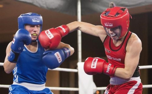 Mandy Bujold, right, of Ontario, lands a blow to the head of Kim Klavel, of Quebec, during their 51kg bout at the Canadian Olympic boxing trials, in Montreal, on Wednesday, Dec. 9, 2015. THE CANADIAN PRESS/Graham Hughes