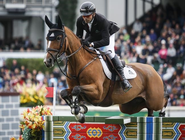 Canada's Eric Lamaze riding Fine Lady 5 during the CP International competition at the Spruce Meadows Masters in Calgary, Alta., Sunday, Sept. 8, 2019. Canada's most decorated show jumper has withdrawn from consideration for the Tokyo Olympics. THE CANADIAN PRESS/Jeff McIntosh