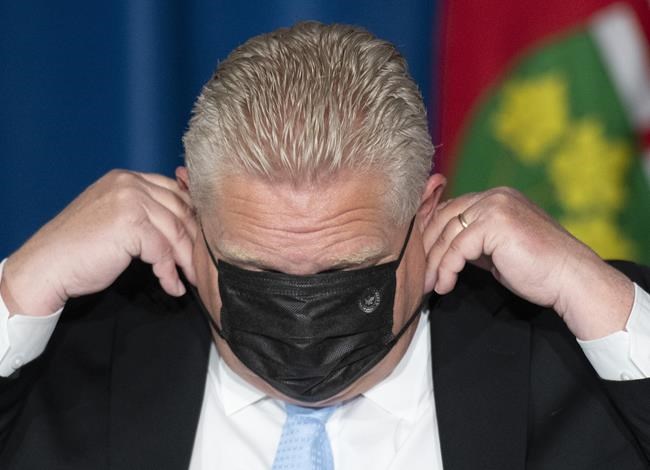 Ontario Premier Doug Ford puts his mask on at a press conference at the Ontario Legislature in Toronto, Thursday, May 13, 2021.THE CANADIAN PRESS/Frank Gunn