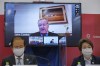FILE - In this May 21, 2021, file photo, CEO of the Tokyo 2020 Toshiro Muto, left, and President of the Tokyo 2020 Seiko Hashimoto, right, listen to IOC Vice President John Coates, (on screen), delivering a speech during the Tokyo 2020 IOC Coordination Commission press conference in Tokyo. Comments from Coates saying the Tokyo Olympics will go on even if the city is under a state of emergency have stirred a backlash in Japan. Coates made the statement a few days ago. He repeated what the IOC and local organizers have been staying, but his tone was almost defiant and has stirred things up. (Nicolas Datiche/Pool Photo via AP, File)