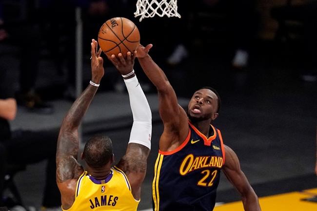 Los Angeles Lakers forward LeBron James, left, has his shot blocked by Golden State Warriors forward Andrew Wiggins during the first half of an NBA basketball Western Conference Play-In game Wednesday, May 19, 2021, in Los Angeles. THE CANADIAN PRESS/AP/Mark J. Terrill