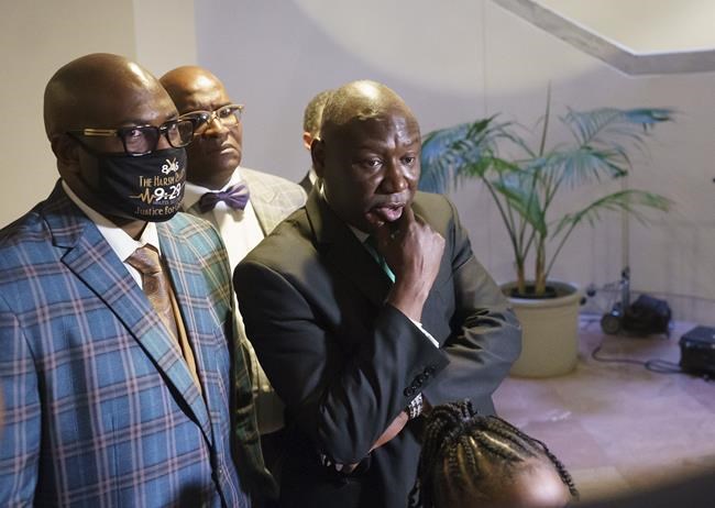 Philonise Floyd, brother of George Floyd, left, and Benjamin Crump, civil rights attorney who represented the family of George Floyd, right, pause for reporters at the Capitol in Washington, after meeting with Sen. Tim Scott, R-S.C., Tuesday, May 25, 2021, the first anniversary of Floyd's death at the hands of a white Minneapolis police officer. (AP Photo/J. Scott Applewhite)