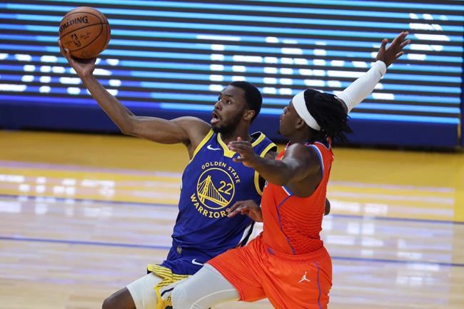 Golden State Warriors' Andrew Wiggins, left, shoots against Oklahoma City Thunder's Luguentz Dort during the first half of an NBA basketball game in San Francisco, Saturday, May 8, 2021. Fourteen NBA players are among 21 players invited to the Canadian national men's basketball team's training camp in Tampa, Fla. THE CANADIAN PRESS/AP/Jed Jacobsohn