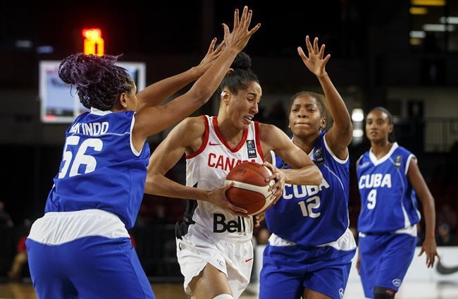 Canada's Miranda Ayim (9) drives between Cuba's Anisleidy Galindo (56) and Nahomis Vargas (12) during second half action of FIBA Women's Olympic Pre Qualifying Tournaments Americas 2019, in Edmonton, Alta., on Thursday, November 14, 2019.THE CANADIAN PRESS/Jason Franson
