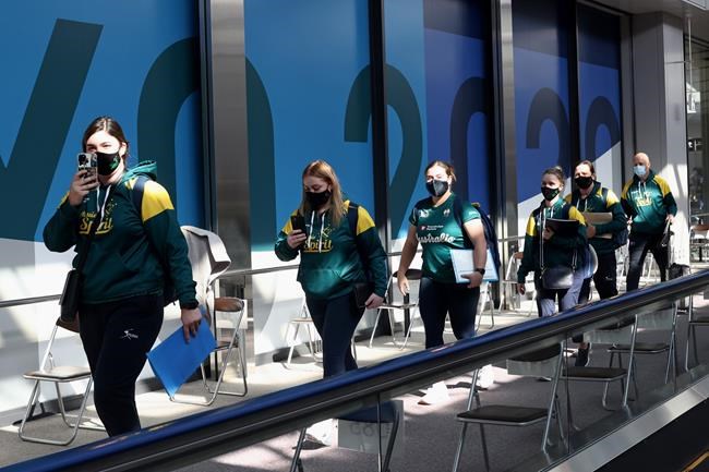 Australian softball national team players arrive at the Narita International Airport in Narita, Chiba, east of Tokyo, Tuesday, June 1, 2021. The Australian team is one of the first teams to arrive ahead of the Tokyo 2020 Olympic games, scheduled to open July 23. (Behrouz Mehri/Pool Photo via AP)
