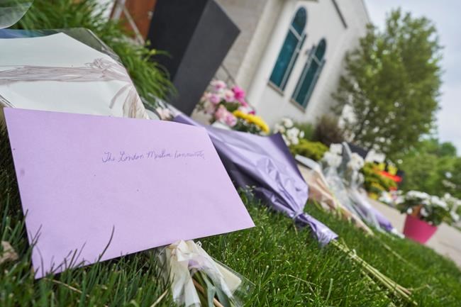 Flowers and cards lay outside the London Muslim Mosque in London, Ont. on Tuesday, June 8, 2021 after a hate-inspired terrorist attack on Sunday left four members of a Muslim family dead and their nine-year-old son in hospital. THE CANADIAN PRESS/ Geoff Robins